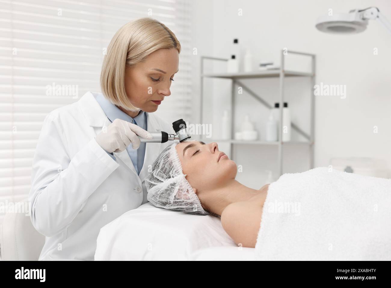 Dermatologist consulting with a patient using a dermoscope